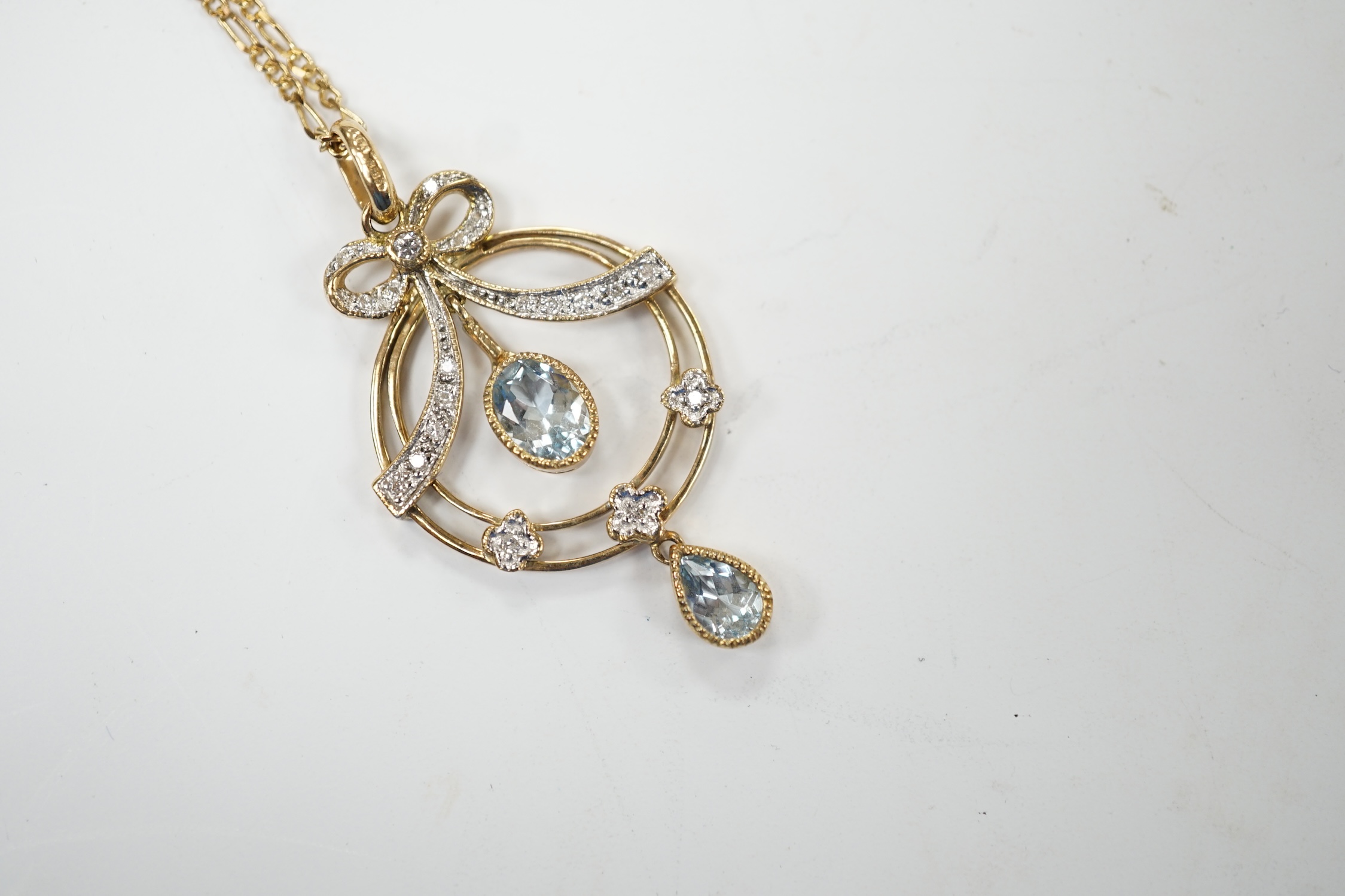 A modern 9ct gold, aquamarine and diamond cluster set drop pendant necklace, pendant 40mm, chain, 44cm, gross weight 5.2 grams. Good condition.